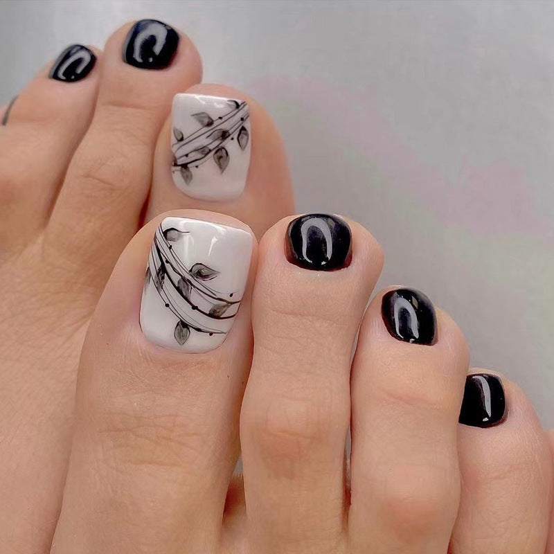 Artful toenail art in elegant black and white design Stornfield