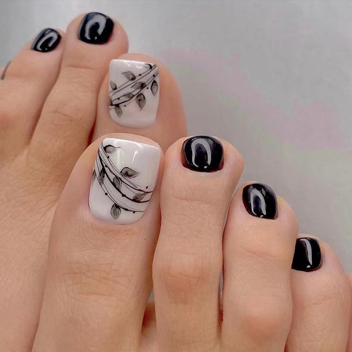 Artful toenail art in elegant black and white design Stornfield