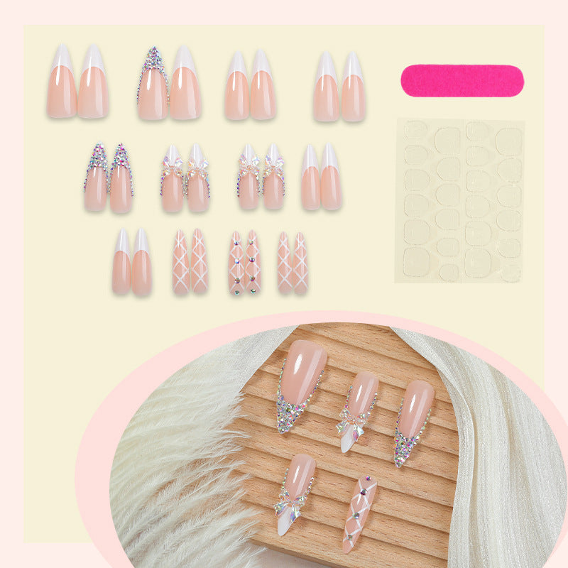 Acrylic nail set with luxurious rhinestone embellishments and bow accents Stornfield