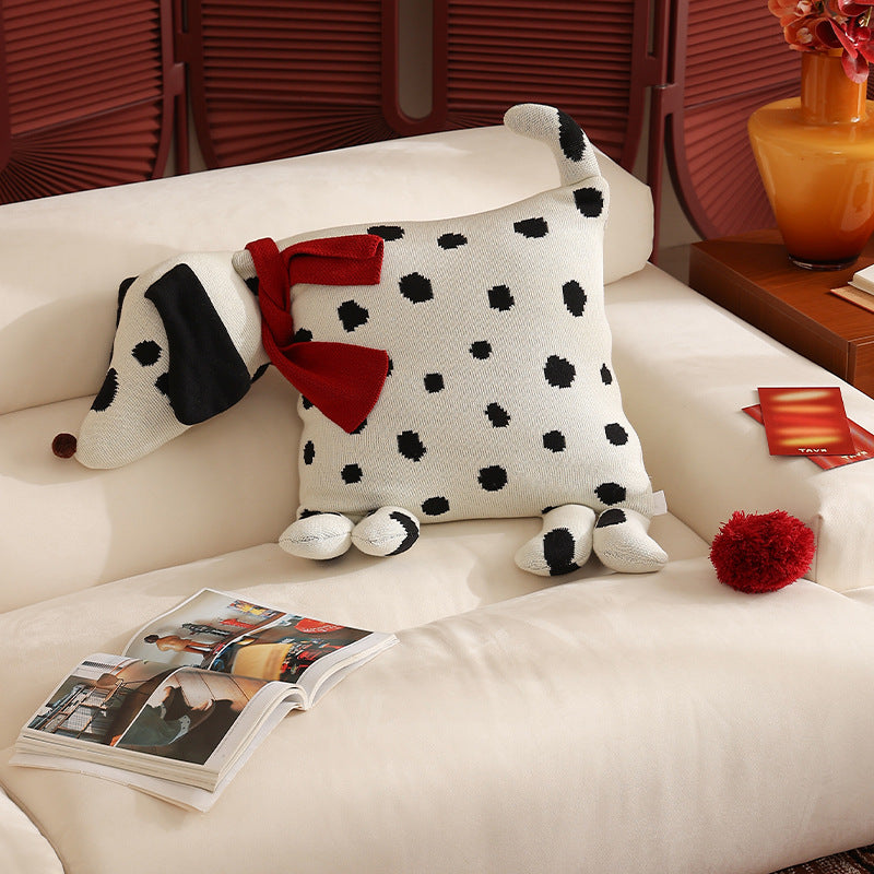 Decorative knitted cuddle pillow in the shape of a dog with a quilted body and bow detail Stornfield