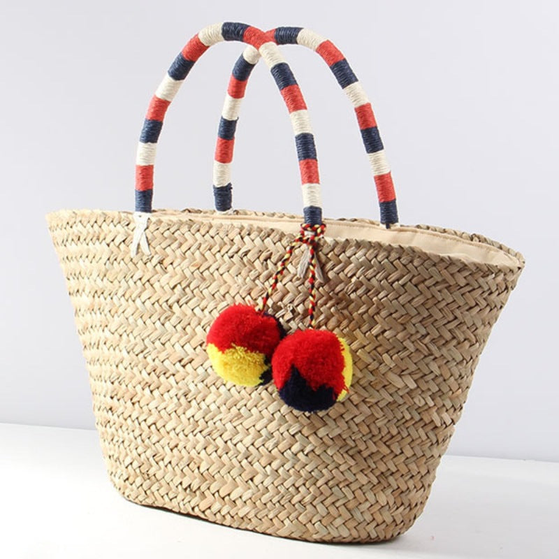 Braided beach bag with decorative pompons Stornfield