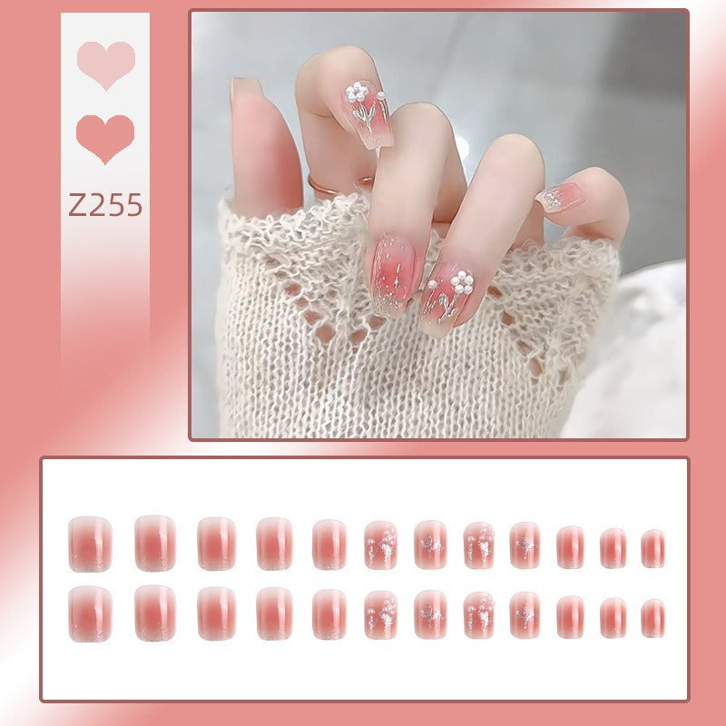 Artificial nail set with floral designs and glitter accents Stornfield