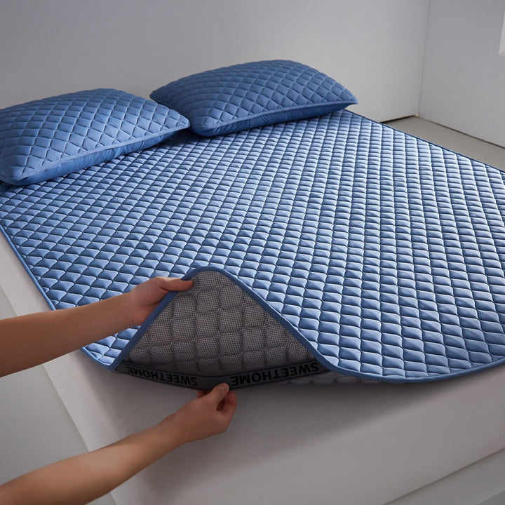 Breathable cooling mattress topper with quilted surface and elastic corner bands