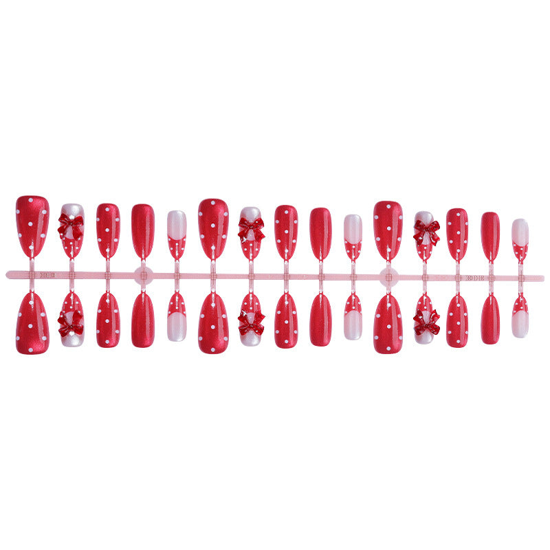 Nail set with playful red polka dots and bow accents Stornfield