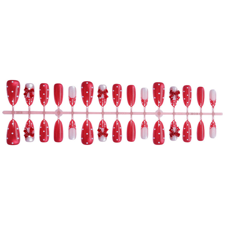 Nail set with playful red polka dots and bow accents Stornfield