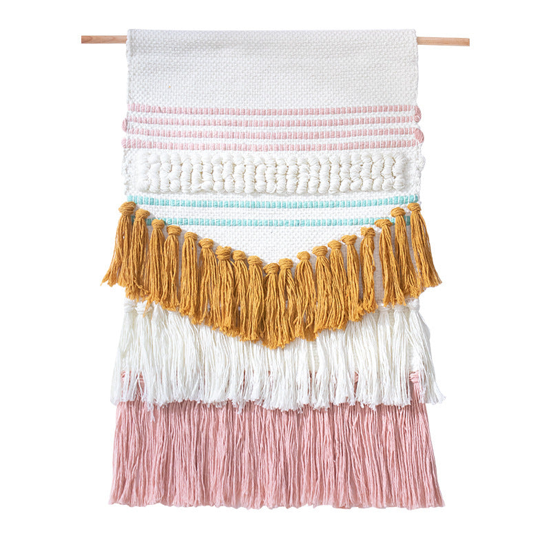 Handwoven wall hanging in boho style with tassels and geometric structure