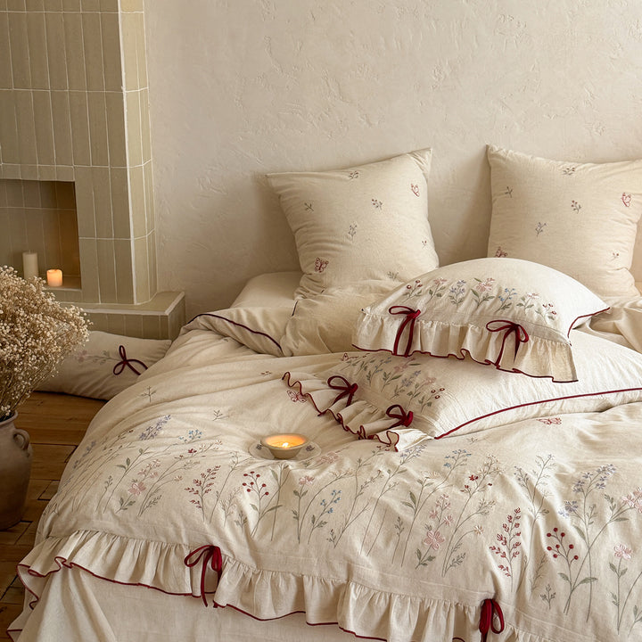 Embroidered cotton-linen bedding set with ruffled trim and bow accents