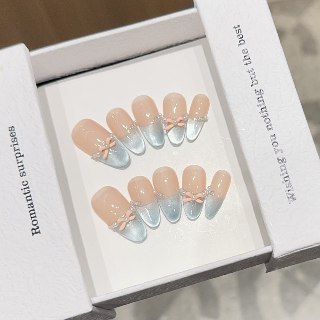 Artificial nail set with romantic bow and glitter accents Stornfield