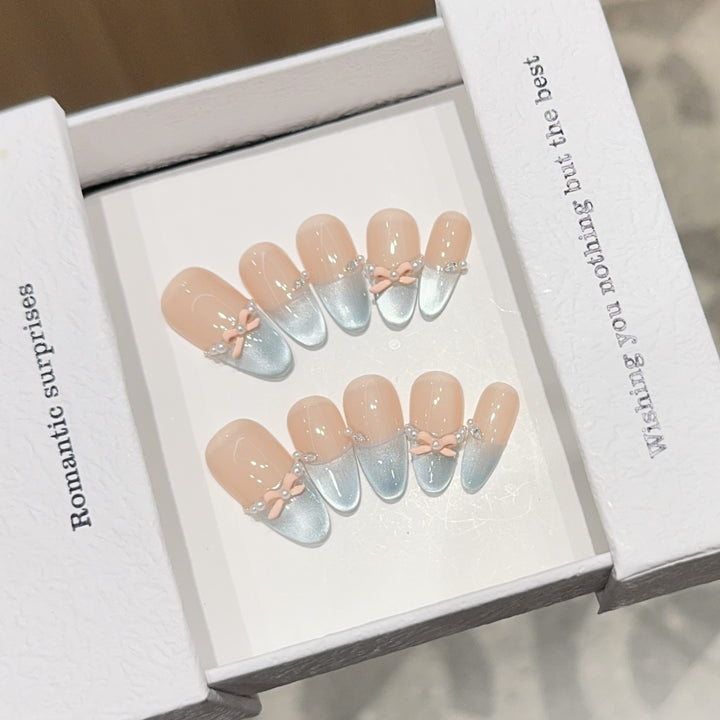 Artificial nail set with romantic bow and glitter accents Stornfield