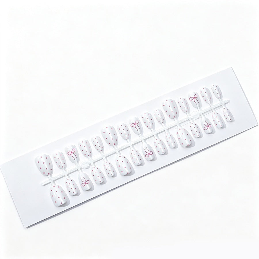 Artificial nail set with delicate dots and bow pattern Stornfield