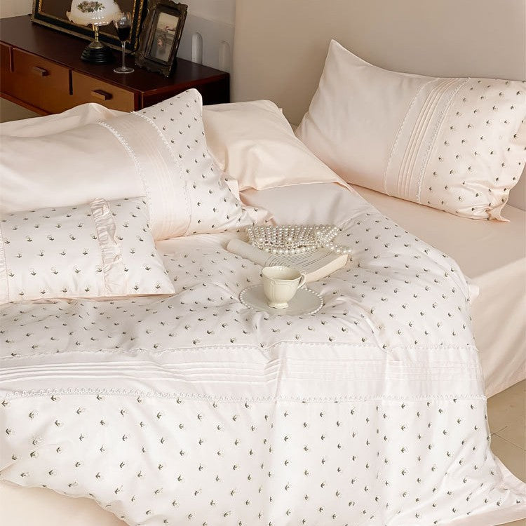 Exclusive satin bedding set with all-over rosebud embroidery and pleating details