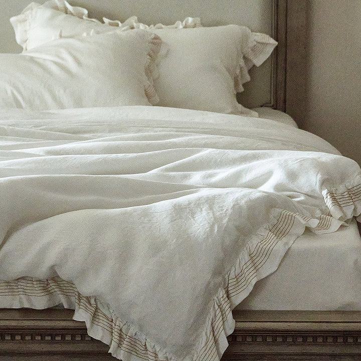 Cotton muslin duvet cover and pillowcase set with ruffle trim and finely striped piping