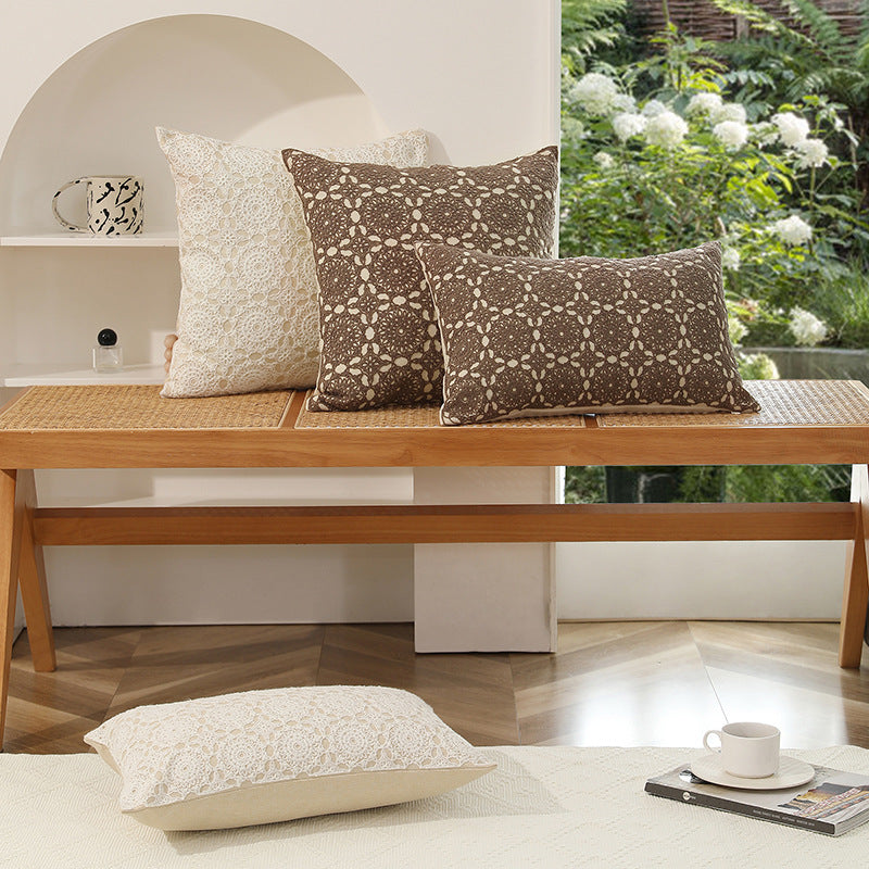 Square decorative cushion with crocheted ornament overlay and linen texture