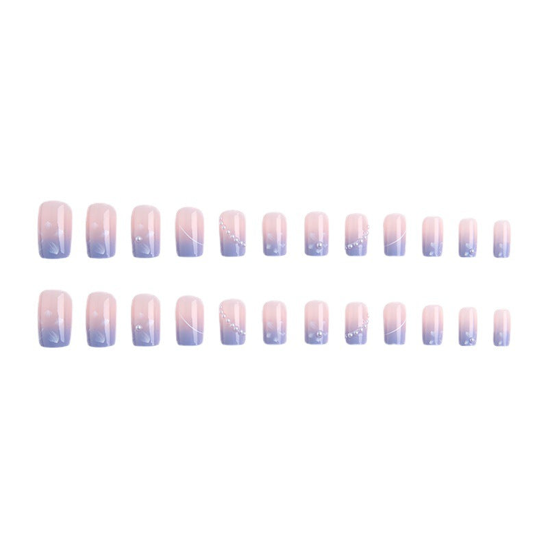 Nail set with elegant floral accents and glitter embellishments Stornfield