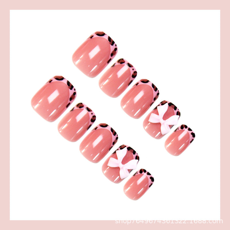 Nail set with playful bow design and lively animal accent Stornfield