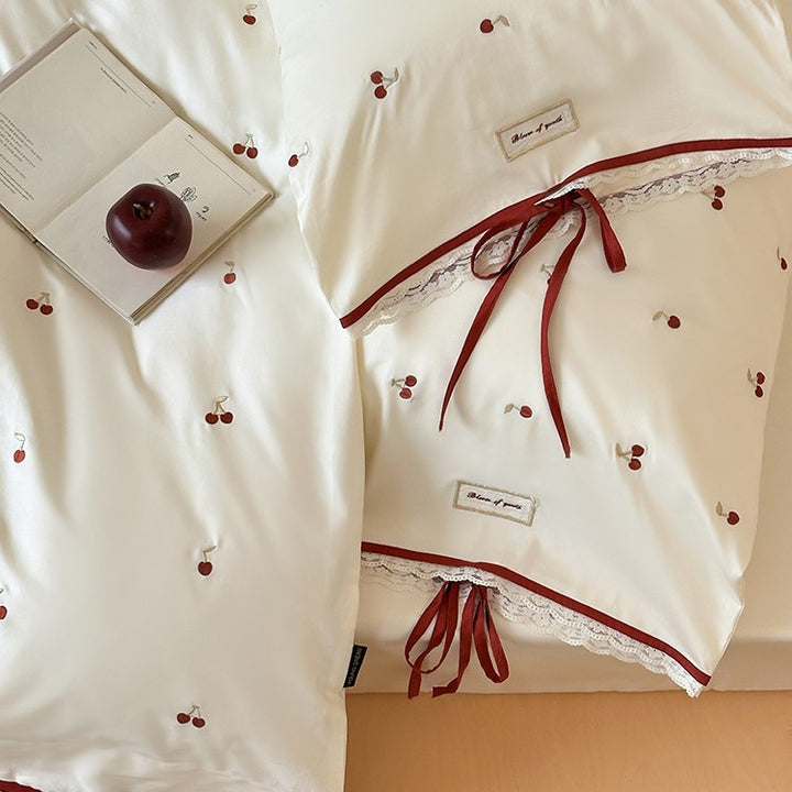 Romantic cotton satin duvet cover set with embroidered cherries, lace trim, and ties