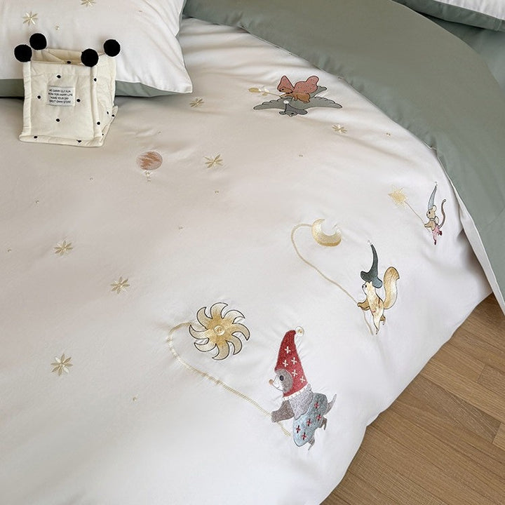 Children's bedding set with embroidered fairy tale forest motifs and reversible option
