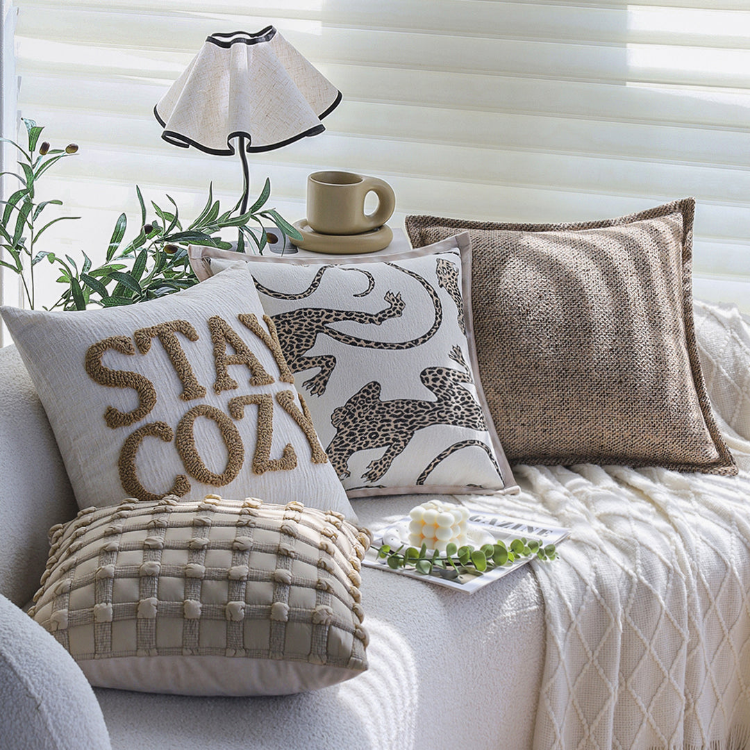 Square decorative cushion cover made of mottled bouclé weave with subtle piping Stornfield