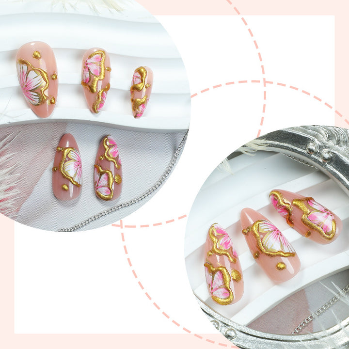 Artificial nails with graceful floral patterns and golden accents Stornfield