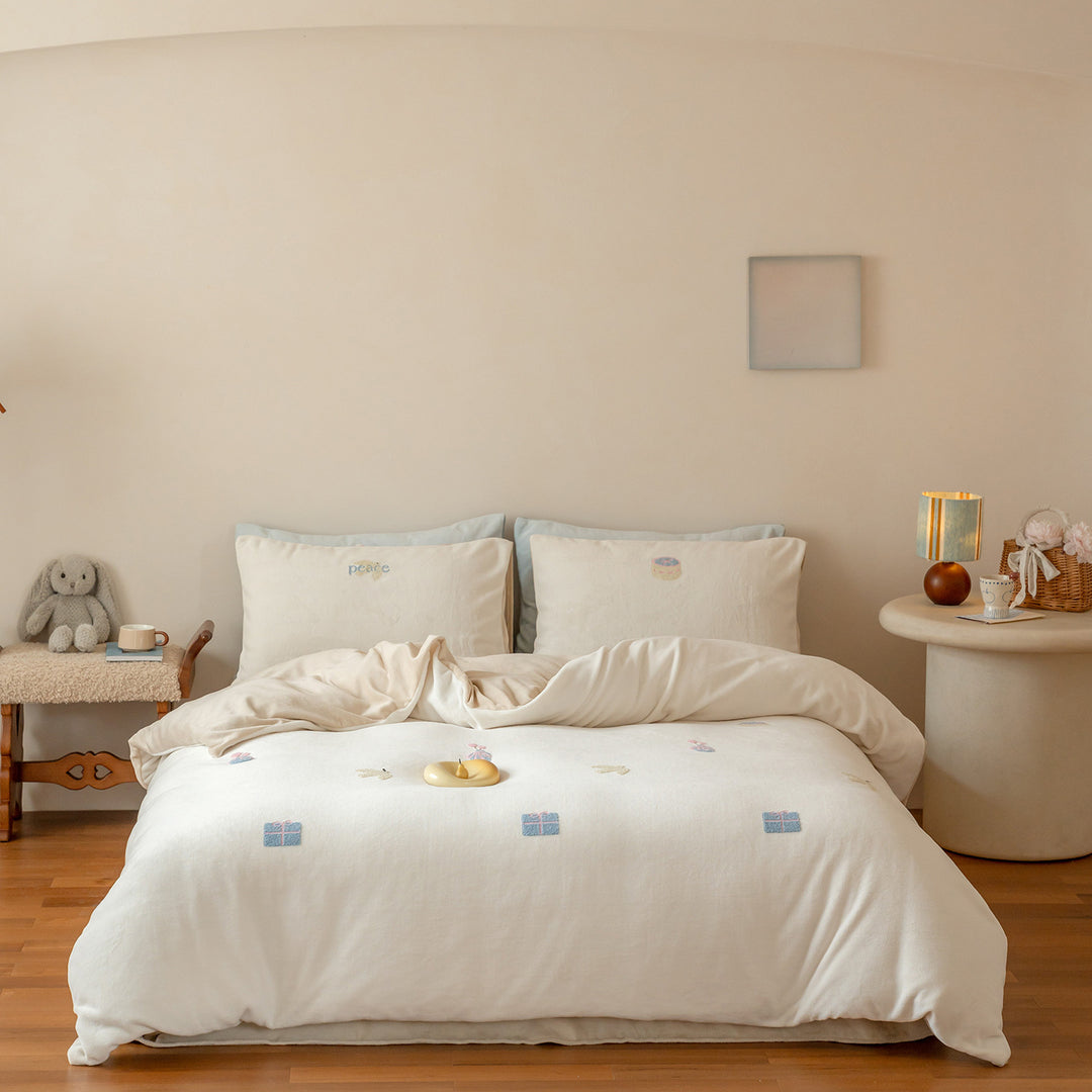 Cozy cotton bedding set with pom-pom appliques and embroidered lettering