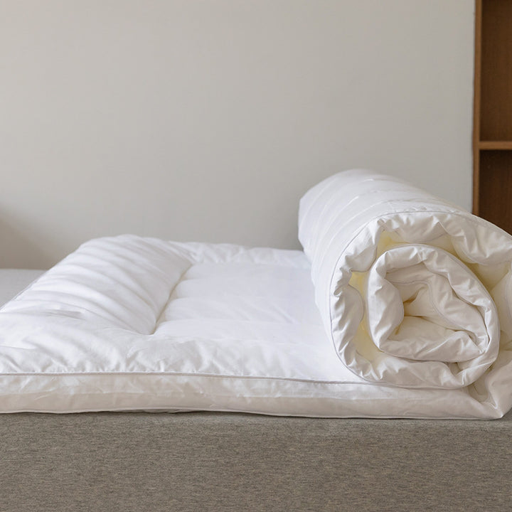 Padded mattress topper with a light down look and breathable hollow fiber filling