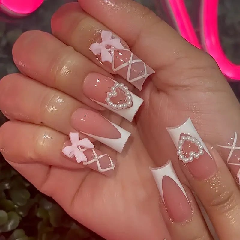 Elegant artificial nail tips with heart and bow accents Stornfield