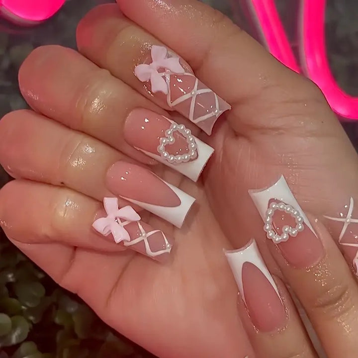 Elegant artificial nail tips with heart and bow accents Stornfield