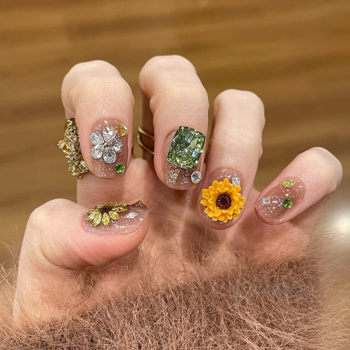 Artificial nails with sparkling appliqués and floral designs Stornfield