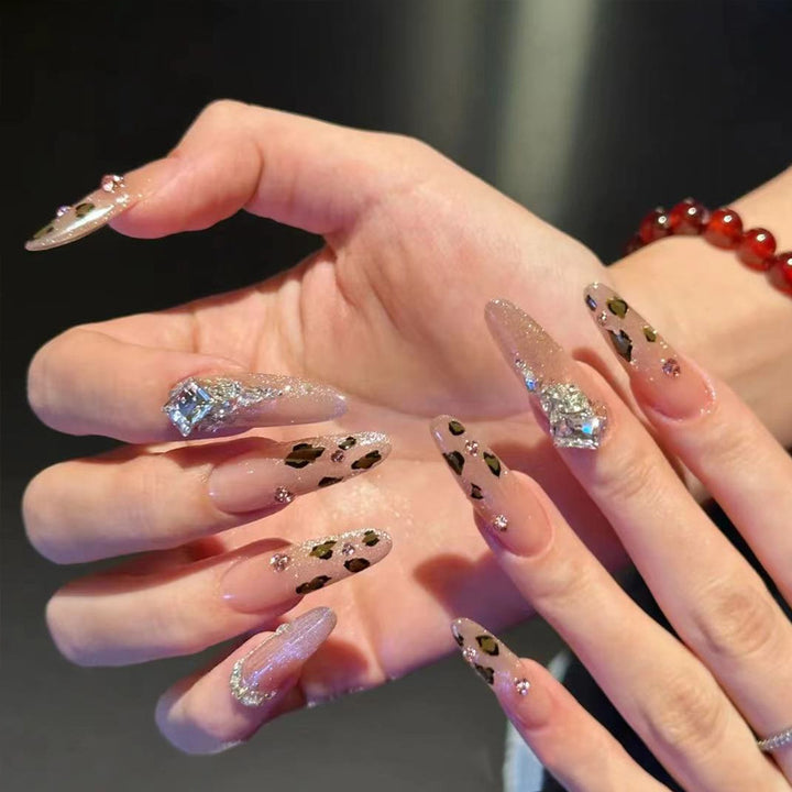 Glamorous artificial nail set with fun leopard pattern and glittering accents Stornfield