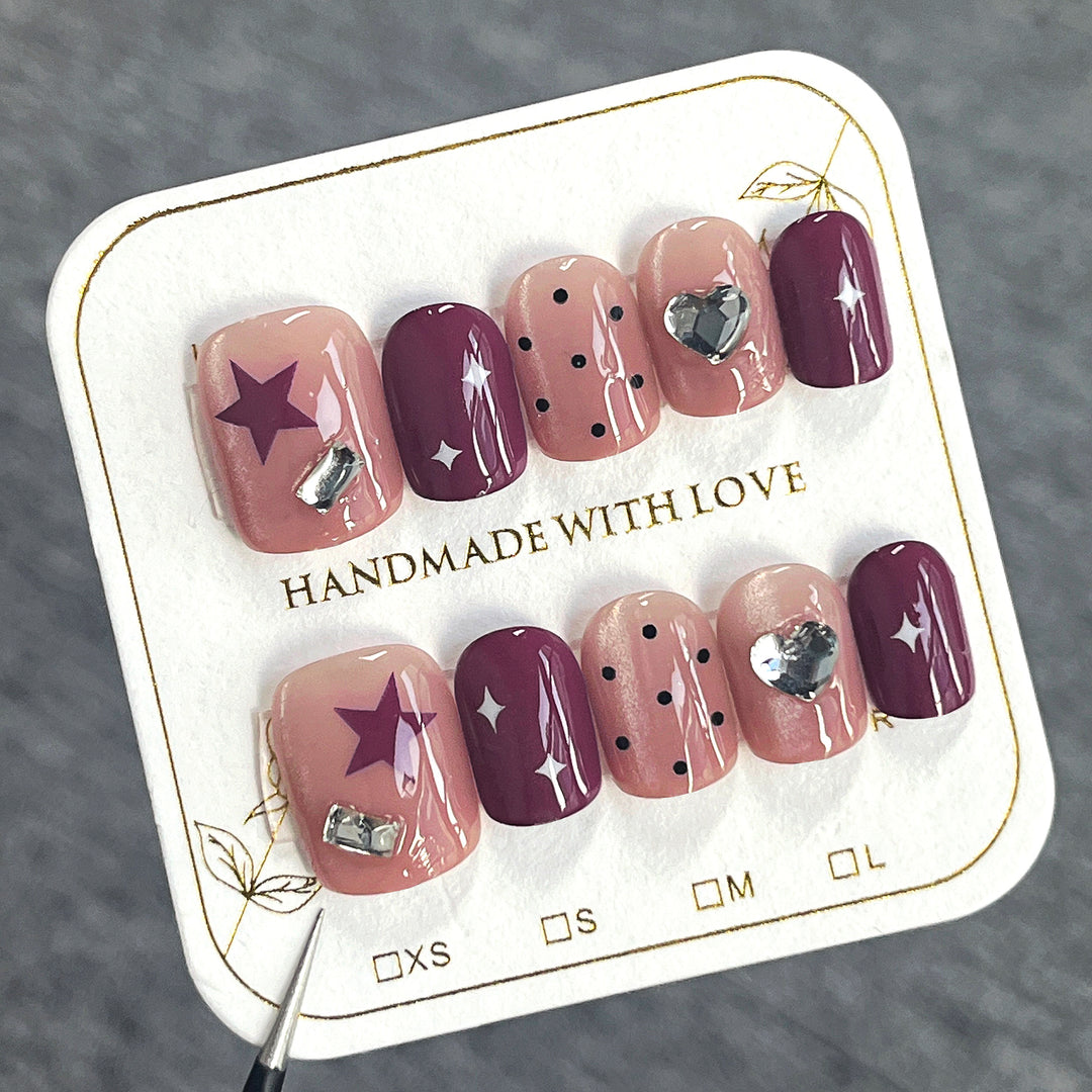Artificial nail extensions with unique jewelry accents Stornfield