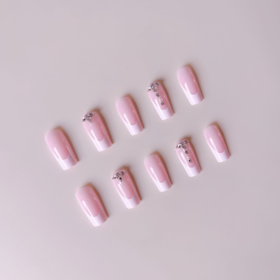 Acrylic nail set with elegant French tips and sparkling rhinestone accents Stornfield