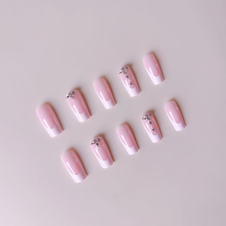 Acrylic nail set with elegant French tips and sparkling rhinestone accents Stornfield