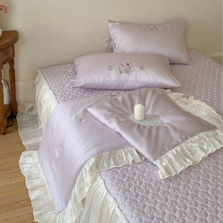 Romantic satin bedding set with ruffle, floral embroidery and tie pillow