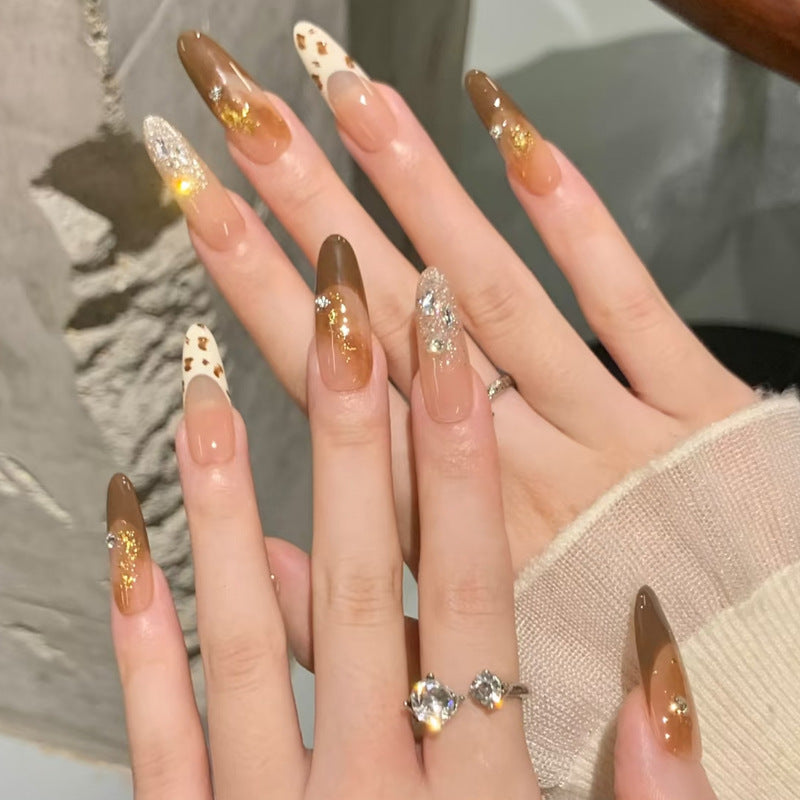 Glamorous artificial nails with creative embellishments Stornfield