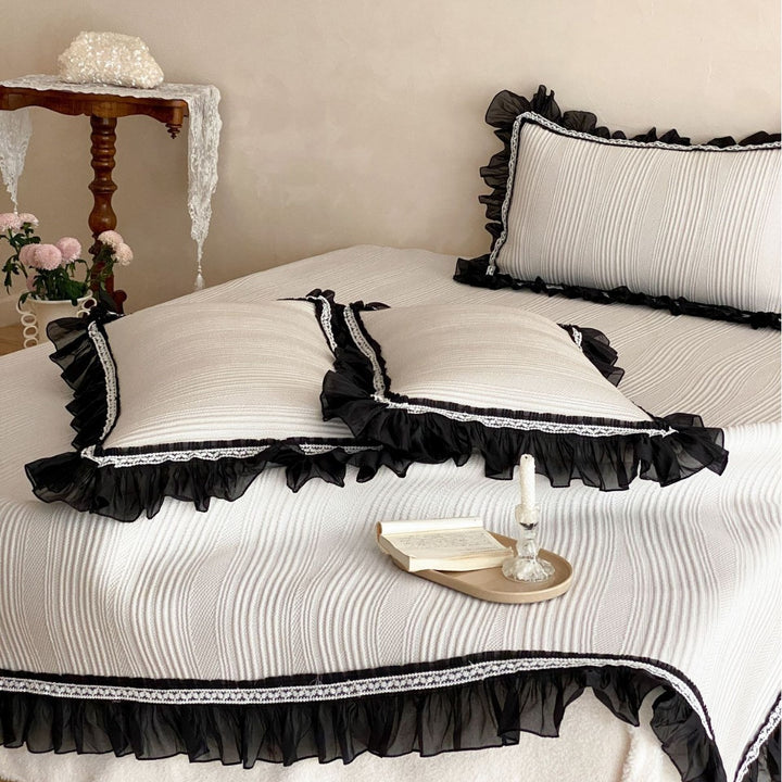 Bedspread with structured wave pattern surface and decorative ruffle trim