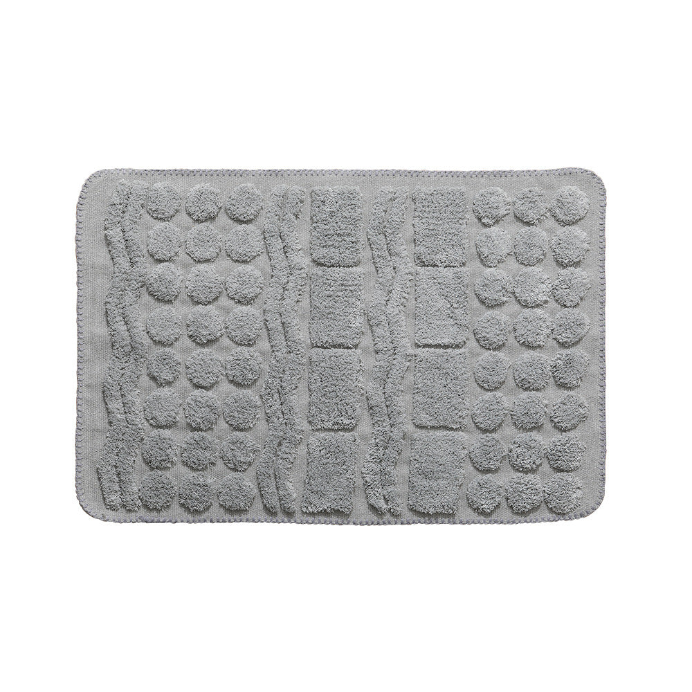 Rectangular cotton bath mat with abstract 3D tuft relief and non-slip back