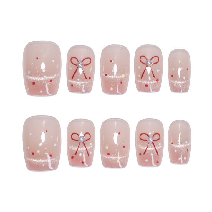 Artificial nail art with elegant bows and glitter accents Stornfield