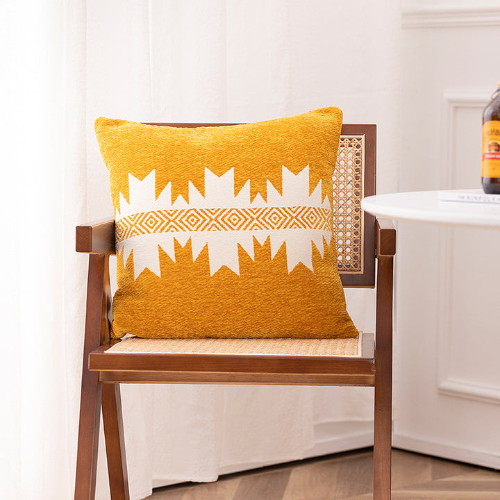 Woven cushion cover with graphic ethnic pattern and contrasting borders