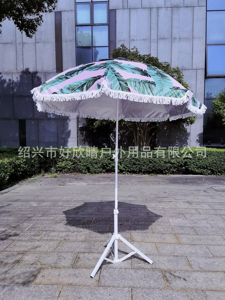Ladies sun umbrella with tropical leaf design and tassel decoration Stornfield