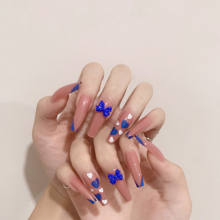 Artful stiletto nails with modern heart and bow motifs Stornfield
