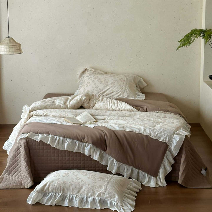 Romantic quilted bedspread and bedding set with ruffle and floral linen look