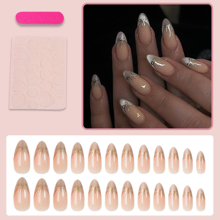 Nail art set with elegant black and white lace design and delicate bow embellishments Stornfield
