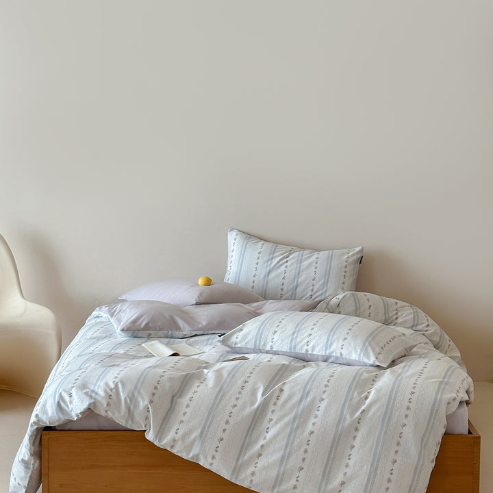 Cotton percale bed linen set with subtle floral stripe pattern and reversible material