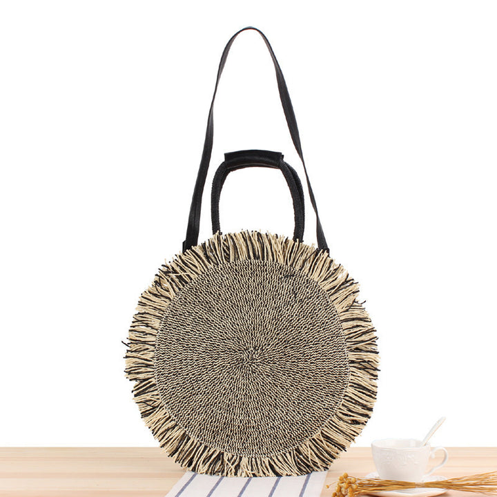 Round Bast shoulder bag with fringes and leather handles Stornfield