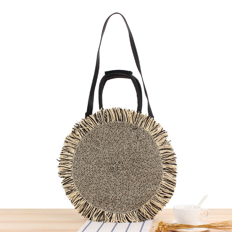 Round bag with fringe decoration Made of woven material Stornfield
