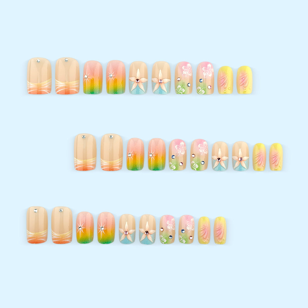 Artificial nails in vibrant floral design with glitter accents Stornfield