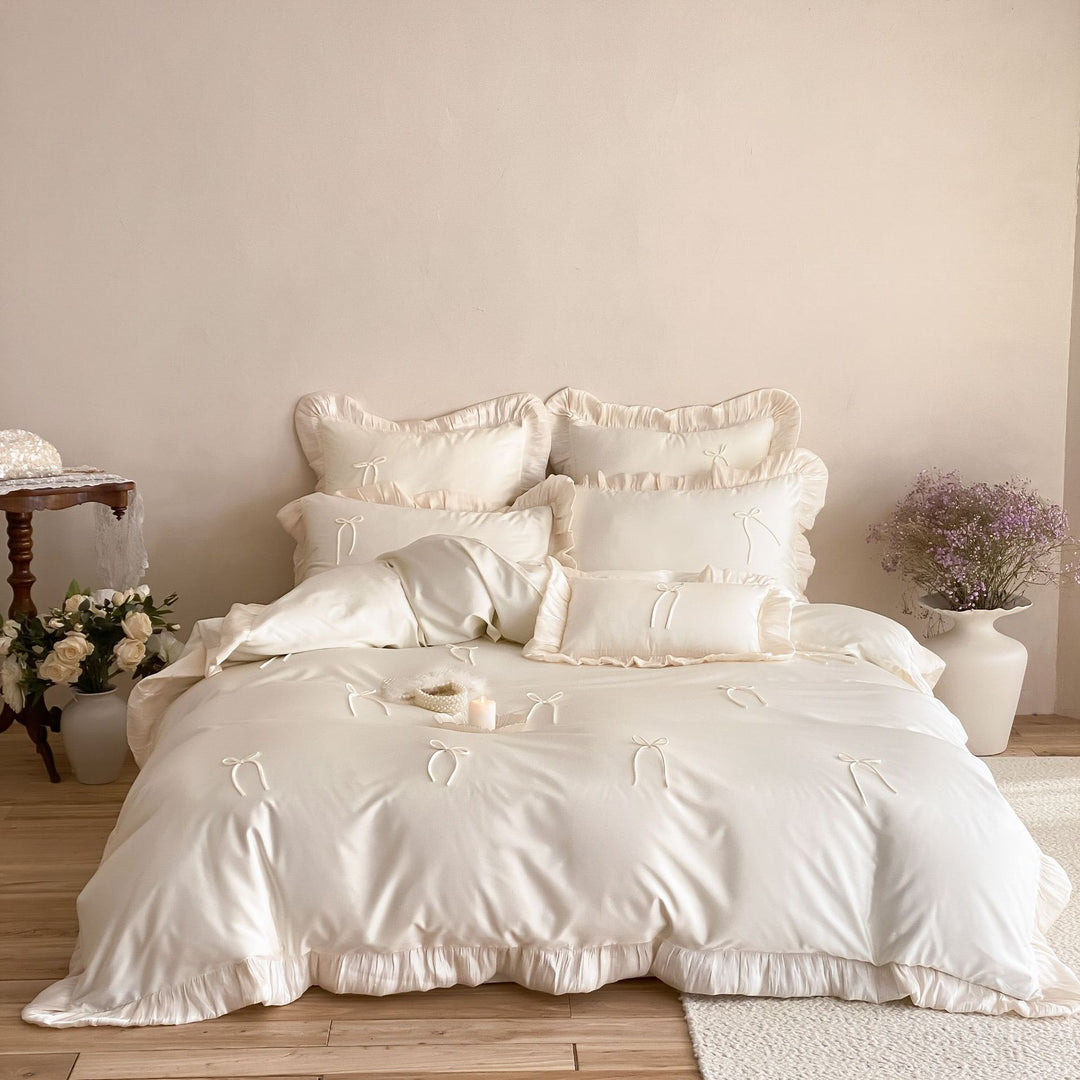 Satin bedding set with ruffle edges, delicate bow appliqué and pillowcases