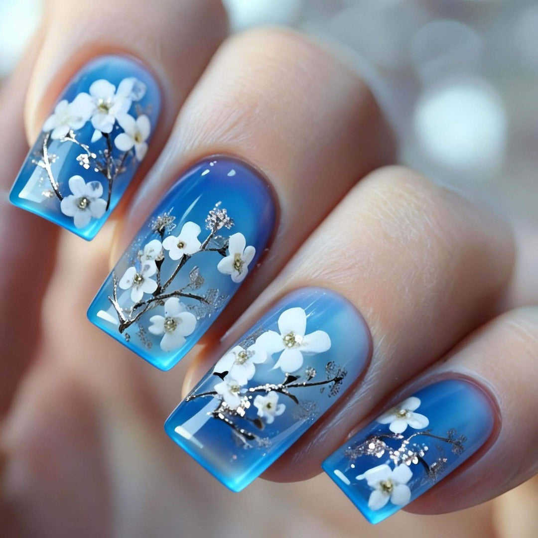 Artificial nail set with floral designs and glitter accents Stornfield