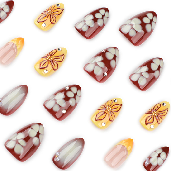 Artificial nail extensions with floral design and rhinestone embellishments Stornfield