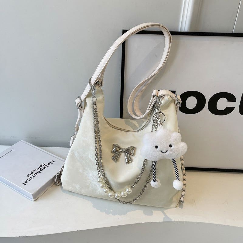 Fashionable handbag with unique pendant and chain accents Stornfield